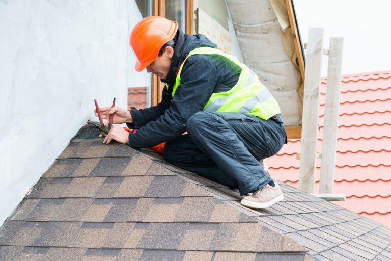 image of a roofer working on a shingle roof